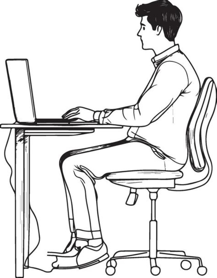a man sitting at a desk in front of a tv with his head on the table