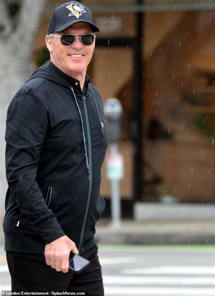 Michael Keaton, 68, looks cheery as he stocks up on groceries with his girlfriend during rare