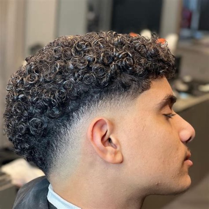 Mid fade with Curls My boy got a mid/low drop fade and left the top